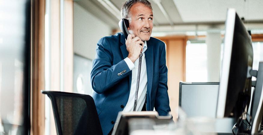 man on telephone looking nervous