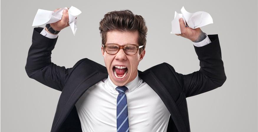 angry man holding wrinkled and ripped paper