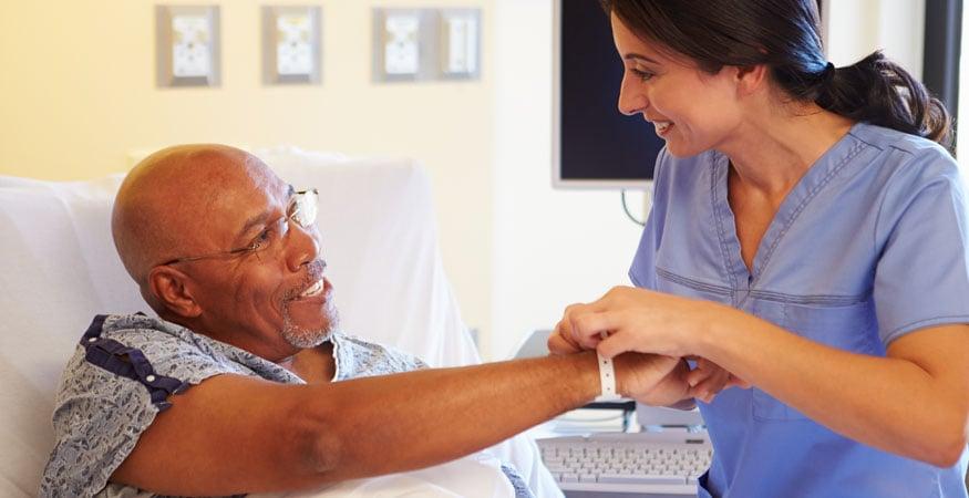 Nurse placing wristband on patient