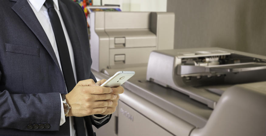 man on phone next to printer