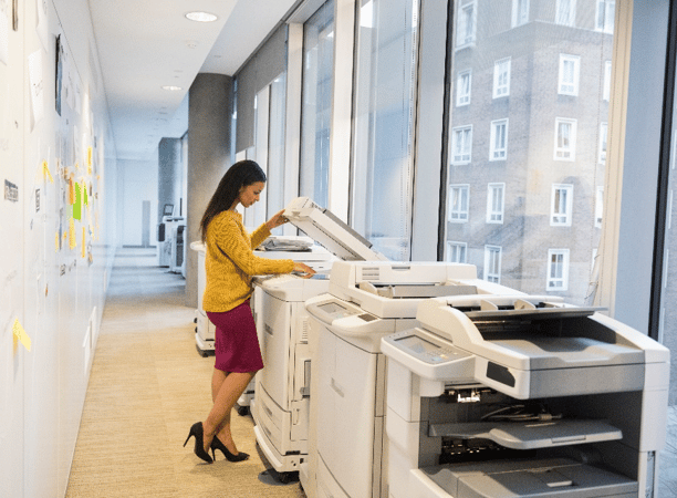 Gordon Flesch employee working on their printer fleet in an office.