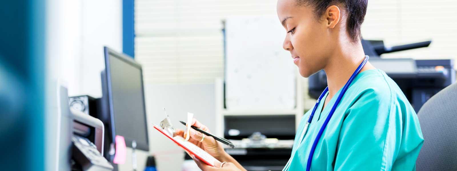 doctor_looking_through_records_at_desk