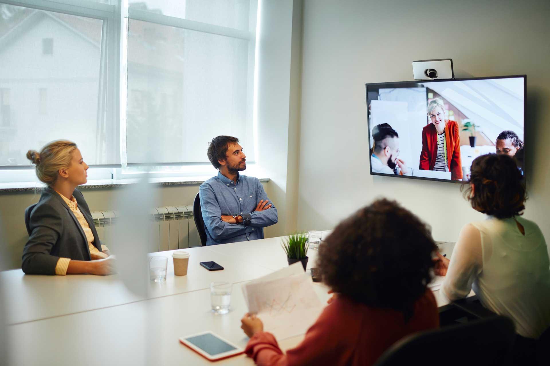 group_in_conference_room_using_conferencing_equipment