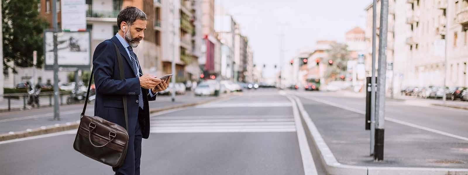 man_on_cell_phone_walking_in_crosswalk