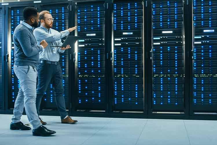 two_men_walking_through_data_center_talking