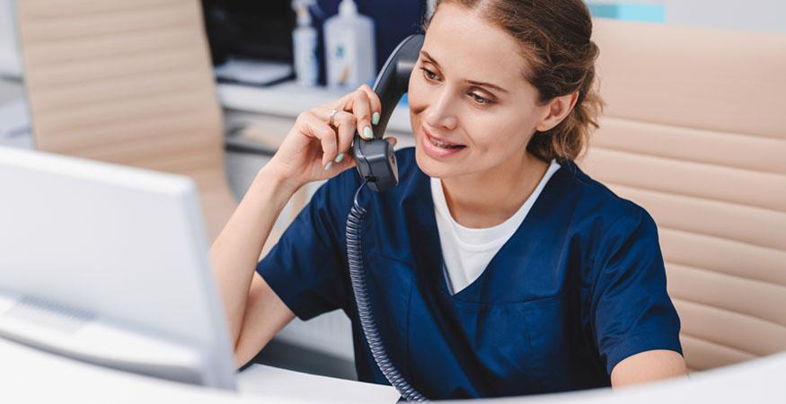 medical worker on the phone speaking with a patient